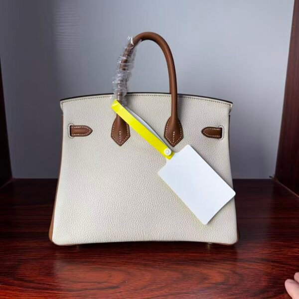 Birkin 25 Handcrafted authentic hand-sewn Togo Leather in Milkshake White & Gold, Gold Hardware Hand stitched Saddle stitch 2 Birkin 25 Handcrafted authentic hand-sewn Togo Leather in Milkshake White & Gold, Gold Hardware Hand stitched Saddle stitch